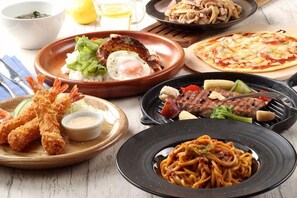 A variety of dishes including fried shrimp, pasta, and a pizza.