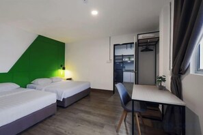 A hotel room with two beds, a desk, and a kitchenette. - Polaris Suite (Kota Kinabalu)