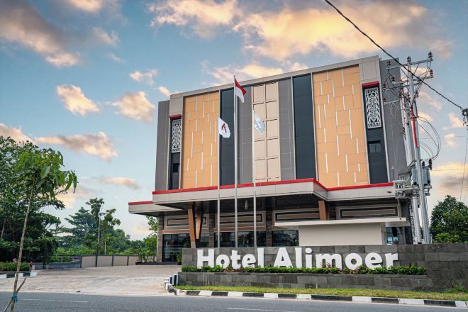 A modern hotel building with a prominent sign reading "Hotel Alimoer."