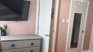 A bedroom with a bed, a dresser, a television, and a ceiling fan. - Cozy 3 bedroom home with perfect location in Saint John (Saint John)