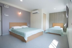 A hotel room with two beds, an air conditioning unit, and a wall-mounted light fixture. - Peace Casa - Homely & Cosy (Butterworth)