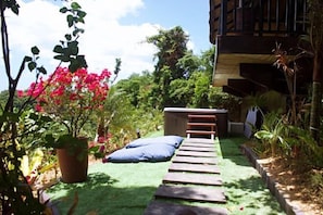 Stroll through the serene garden, surrounded by lush plants and a tranquil seating area.