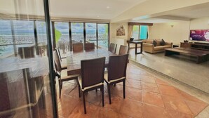 A spacious living area with a large dining table, comfortable seating, a sofa, and a TV. - Villa Goodwill Beach House 3bedrooms on Beach front & private pool Patong Phuket (Tambon Patong)