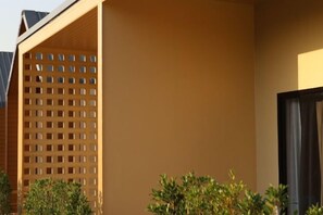 Une façade d’immeuble avec une structure en treillis et une porte sombre.