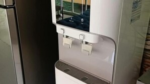 A water dispenser with a digital display and two water taps. - Cow B Homestay Semporna (Semporna)