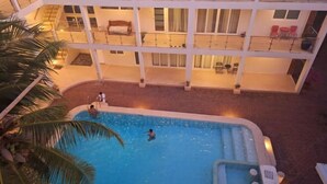 A multi-level hotel with a swimming pool on the ground floor. - Spacious 2BR Boracay Luxury Condo (Boracay Island)