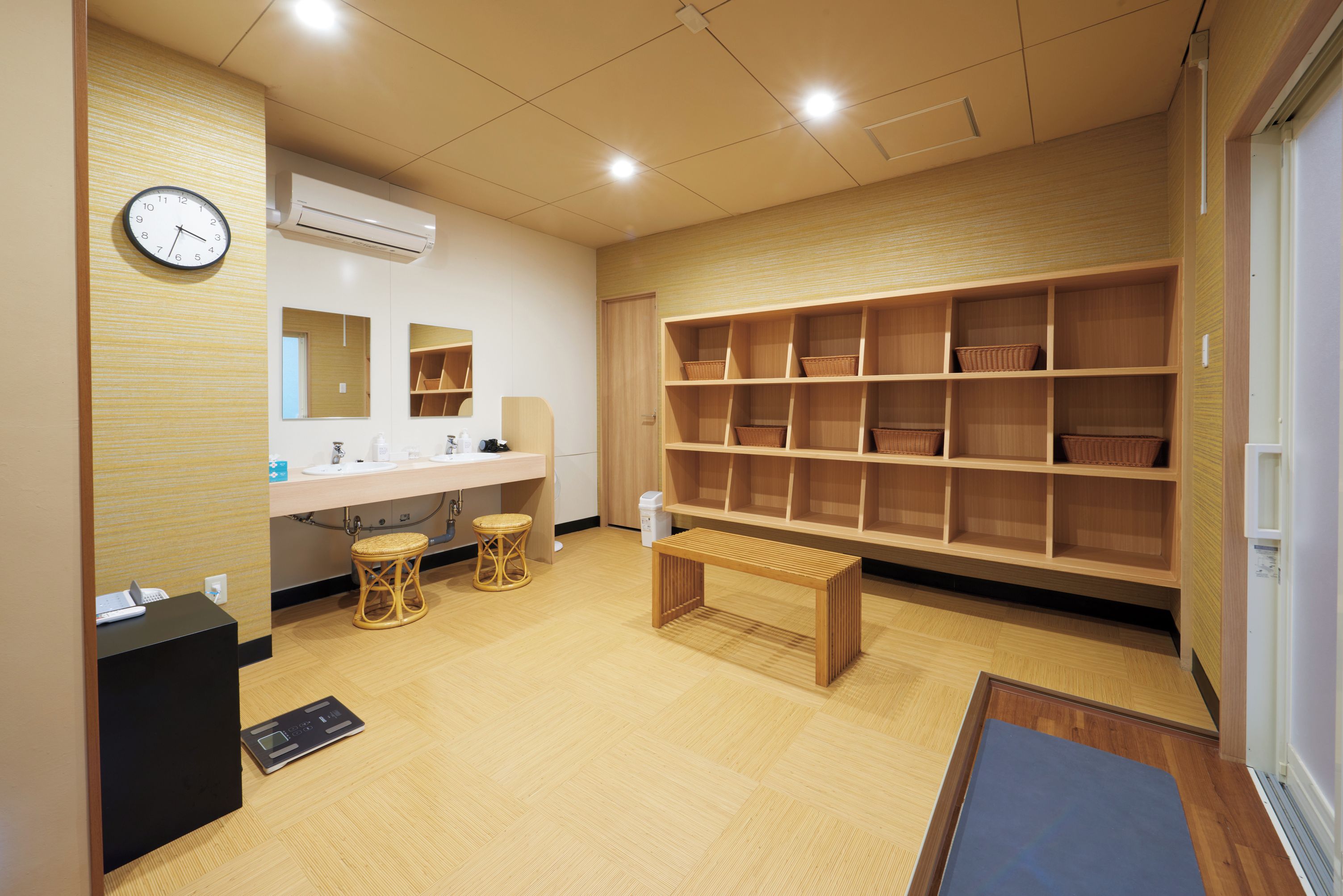 A modern bathroom with a sink, mirror, and shelves for storage.