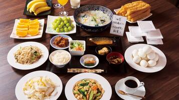 Ein Tisch mit verschiedenen Speisen, darunter Sushi, Reis und Gemüse, was auf eine japanische Mahlzeit hindeutet.
