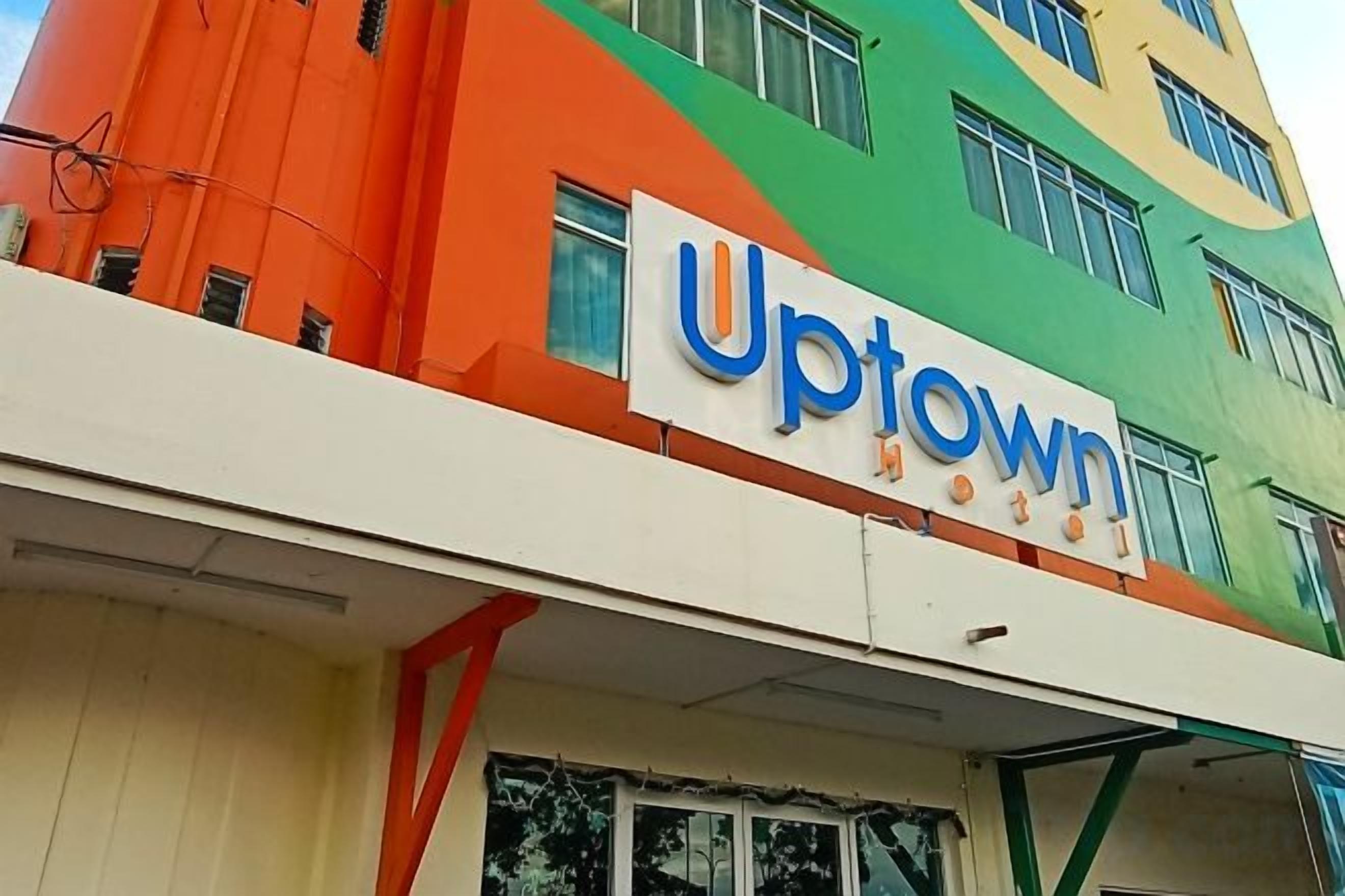 A building with a sign that reads 'Uptown.'
