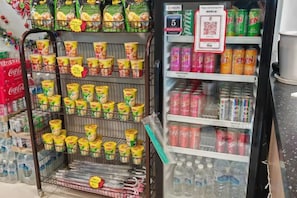 A refrigerated display with various beverages and snacks. - Uptown Hotel (Semporna)