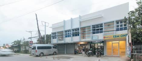 A two-story building with a pharmacy on the ground floor and a restaurant on the upper level.