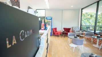 A modern interior with a reception desk, seating area, and large windows.