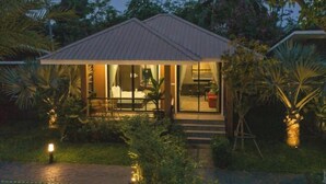 A small, single-story house with a metal roof, surrounded by lush tropical vegetation. - Seeview Resort (Phetchabun)