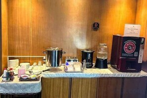 A breakfast bar with coffee machines, a tea kettle, and various breakfast items. - The D257 Hotel (Phetchabun)