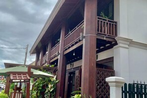 A two-story building with a balcony on the upper floor.