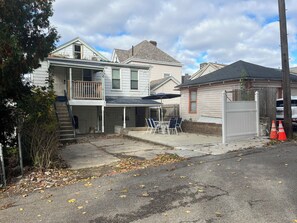 A residential area with houses, a covered patio, and a street.