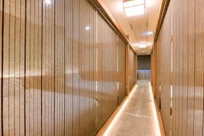 A corridor with vertical blinds, a tiled floor, and a ceiling light fixture. - Yokohama Stay Premier (Yokohama)
