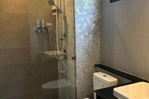 A modern bathroom with a glass-enclosed shower, a toilet, and a sink. - Jaidee Pool Villa (Hat Yai)