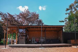 A covered outdoor seating area with tables and chairs, a wooden pergola, and a clear sky. - Bulls Camp -Guesthouse with pets at the foot of World Heritage Mt.Fuji- (Narusawa)