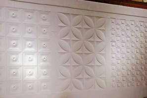 A wall with geometric patterns and recessed lighting. - sungai ujong homestay (George Town)