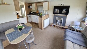 A compact living space with a kitchenette, a dining area, and a seating area.