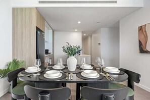 Enjoy meals with friends and family at this stylish dining area, featuring a round table and comfortable seating for six.