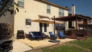 A house with a patio area featuring outdoor furniture, a grill, and a pergola. - This home is minutes away from:
SEA WORLD
FIESTA TEXAS
RIVERWALK
4 JOINT BASES + (San Antonio)