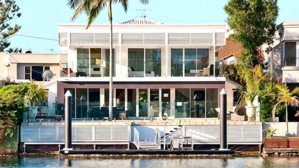 A modern two-story house with large windows, a balcony, and a pool. - Surfers Paradise Escape (Heated Pool) (Surfers Paradise)