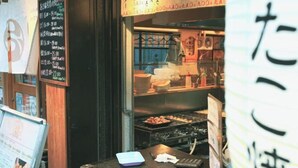 A sushi restaurant with a menu board and a grill area visible through the window. - leopard Shinsaibashi (Osaka)