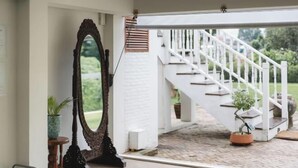 A staircase leading to a covered outdoor area with potted plants and a large mirror. - Phi Private Villa: Luxury 4 beds Riverside & Pool: Near old townBreakfast, Laundry, Free pickup (Chiang Mai)