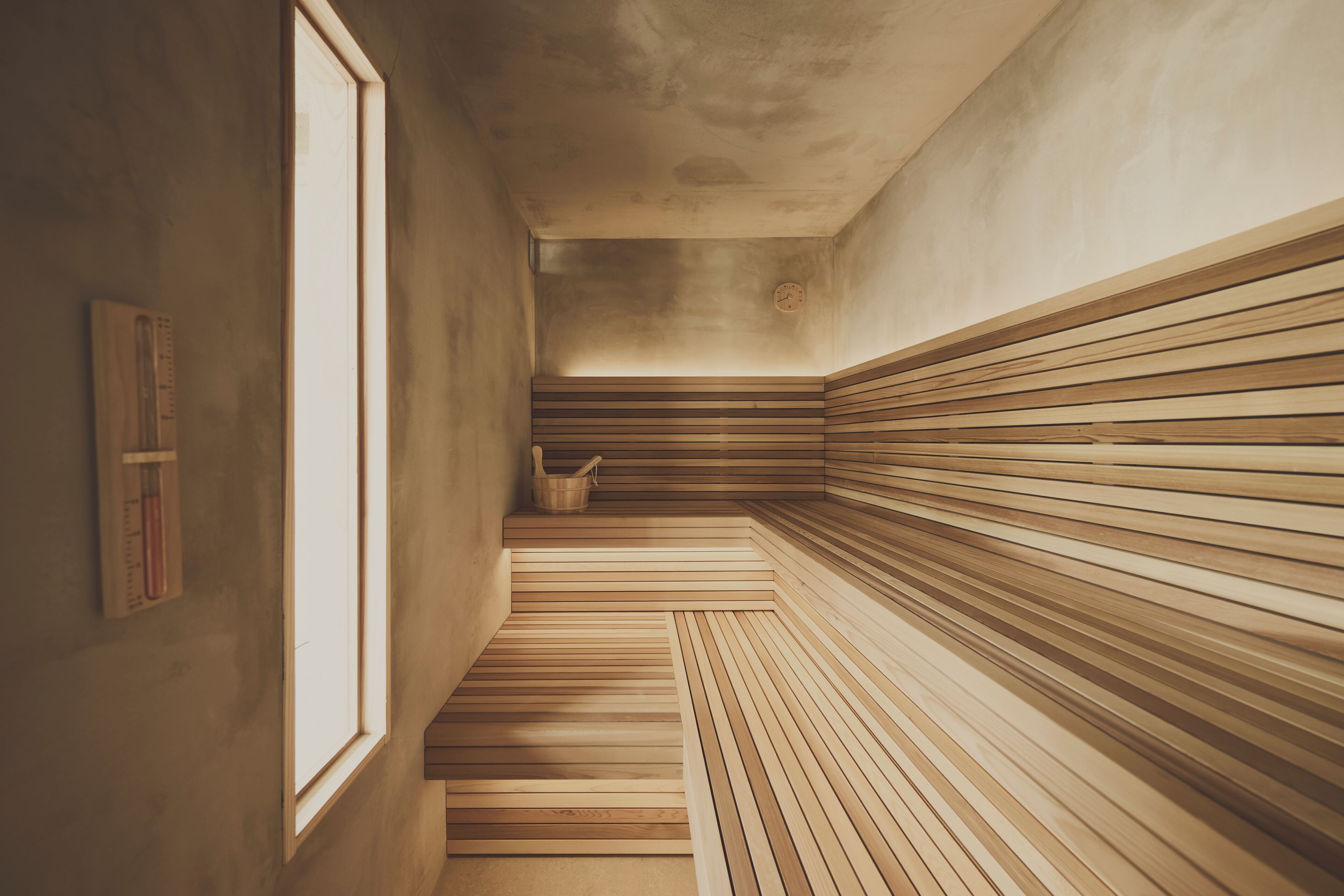 A sauna with wooden benches and a window.