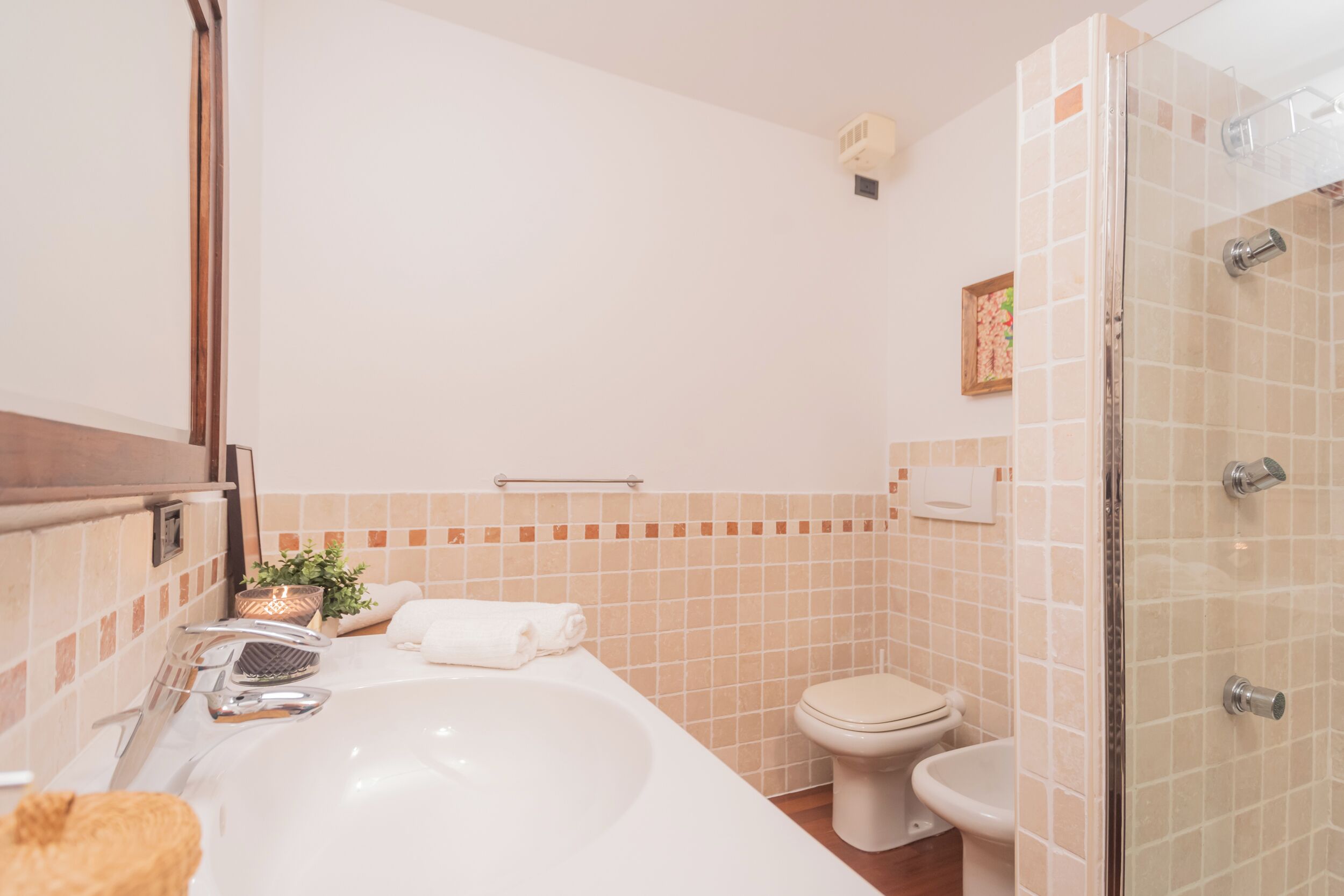 A bathroom with a bathtub, toilet, and sink.