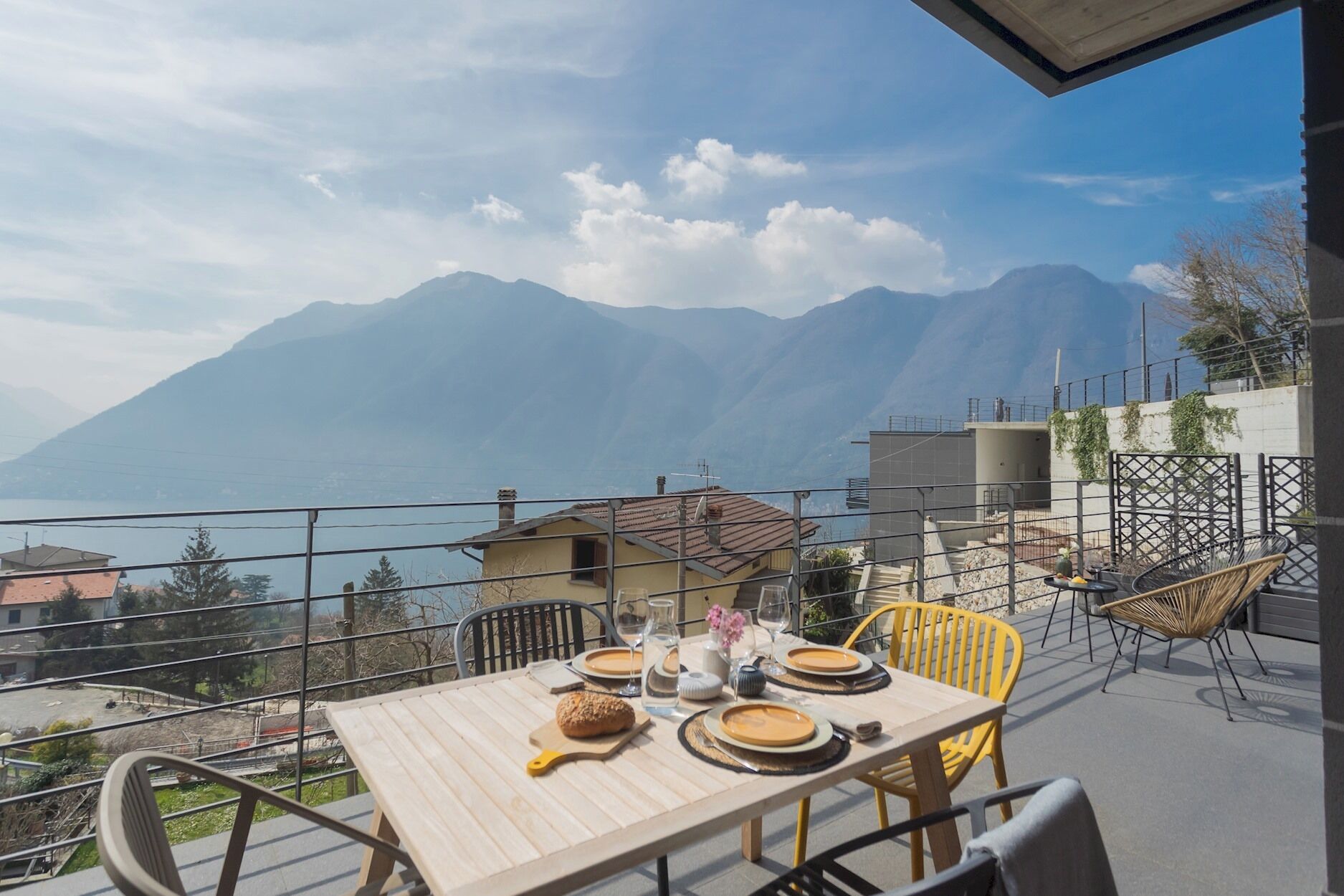 A dining table set outdoors with a mountain view.