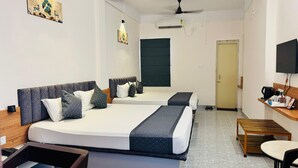 A hotel room with two beds, a desk, a chair, and a television. - Hotel Insta 18 (Siliguri)