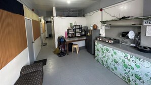 Eine kleine Küche mit Kühlschrank, Herd und einer Essecke.