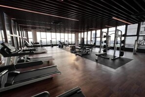 A gym with treadmills, weight machines, and exercise mats. - Bali Residence Melaka by Jeffery Lam Home Management (Melaka)