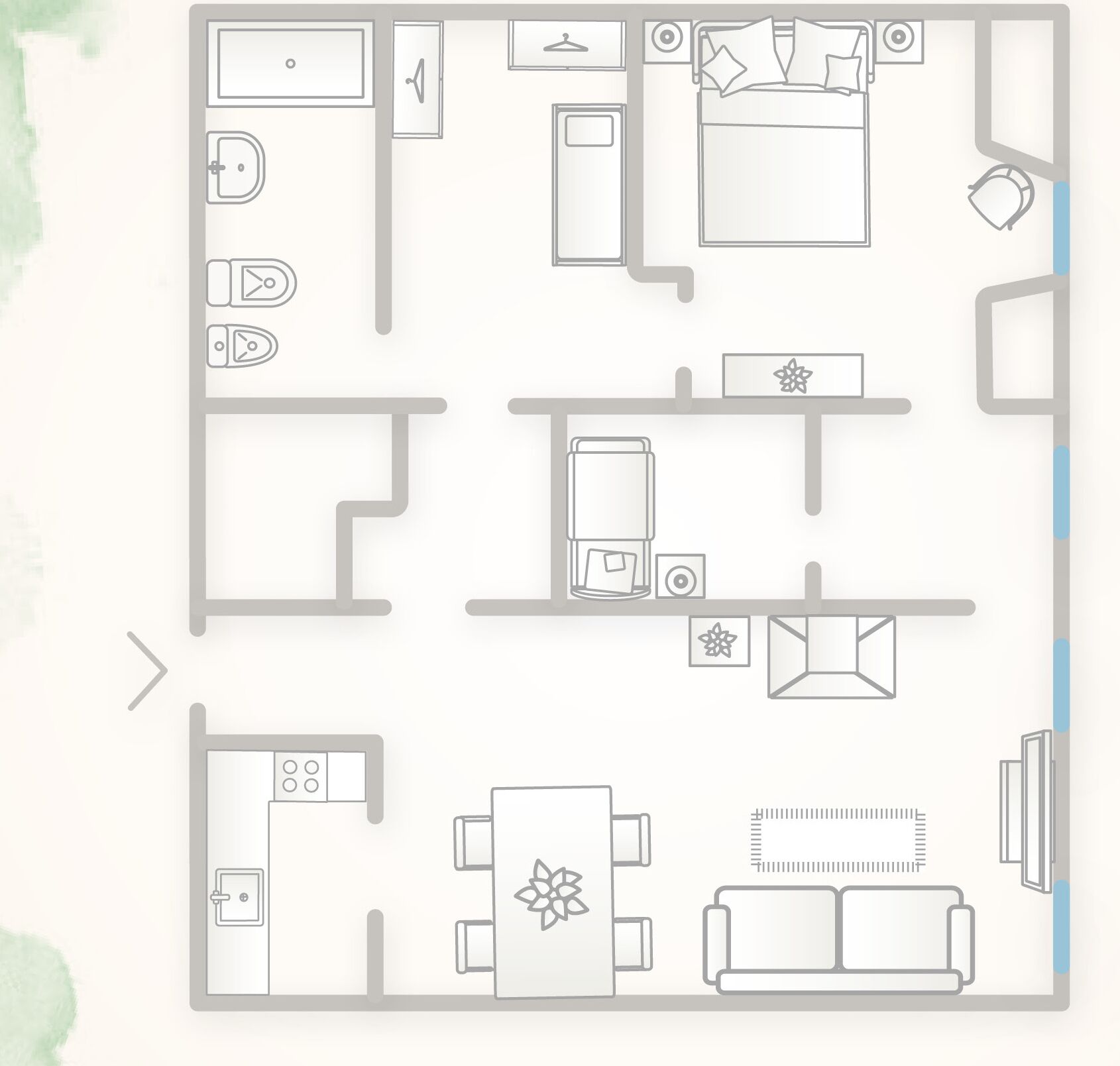 A floor plan of a hotel room with a bed, a desk, a chair, a small table, a sofa, and a bathroom.