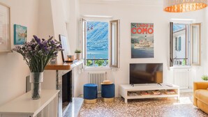 Un salon avec une cheminée, un téléviseur et une vue sur la mer.