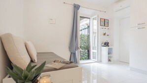 Apartment (1 Bedroom) | Living area | 32-inch flat-screen TV with cable channels - Luce Apartment by Rent all Como (Como)