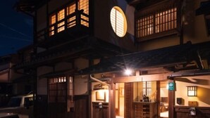 A traditional Japanese-style building with wooden architecture, a visible entrance, and a vehicle parked outside. - Shimizu Kozuki 6min walk to Kiyomizu-dera Temple (Kyoto)