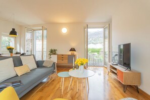 Apartment, 1 Bedroom (Ponente Balcony) | Living area | 32-inch Smart TV with digital channels