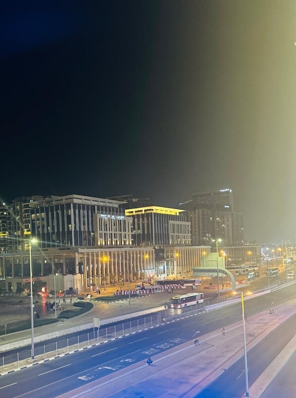A modern building with a unique architectural design, featuring a prominent curved structure and multiple levels. - SKY VIEW HOTEL (Dubai)