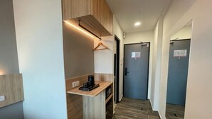 A hallway with a kitchenette area, a trash bin, and a door with a sign. - DJ Citi Plaza Hotel & Suites (Kuala Terengganu)