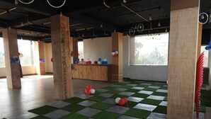 A spacious indoor area with a checkered floor, wooden pillars, and a window providing natural light. - Mystic Moments (Nawada)