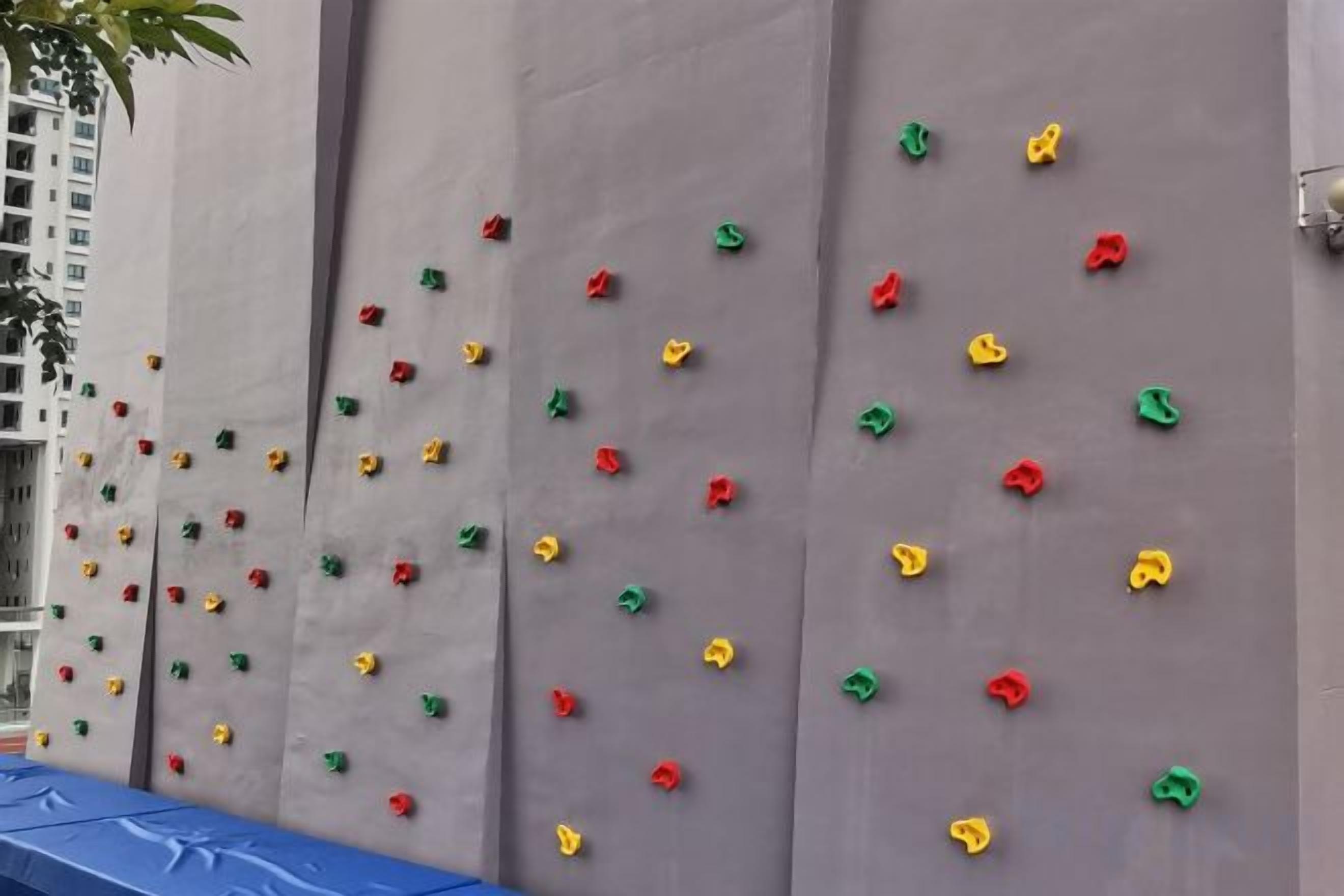 A wall with climbing holds arranged in a pattern.