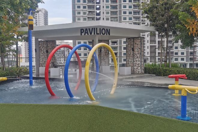 A water play area with colorful rings and a pavilion labeled 'PAVILION' in the background.