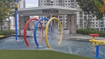 A water play area with colorful rings and a pavilion labeled 'PAVILION' in the background.