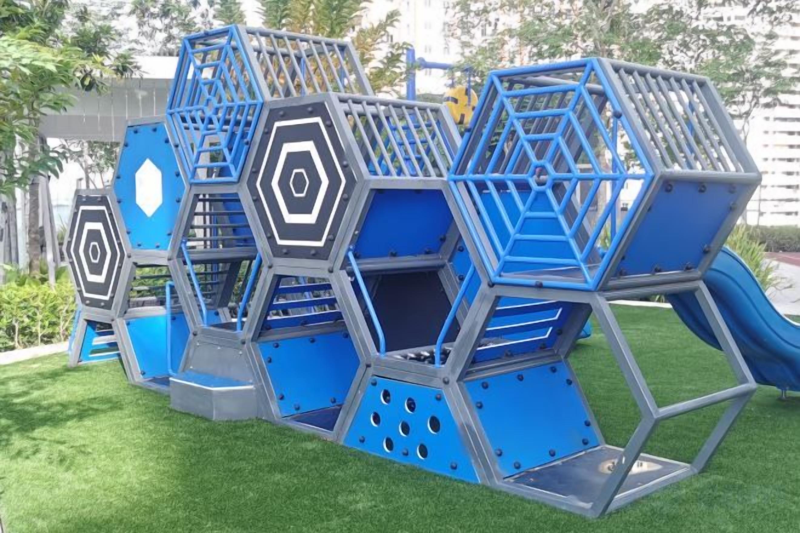 A playground with multiple climbing structures and slides.