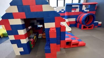 A play area with a large play structure and a slide.