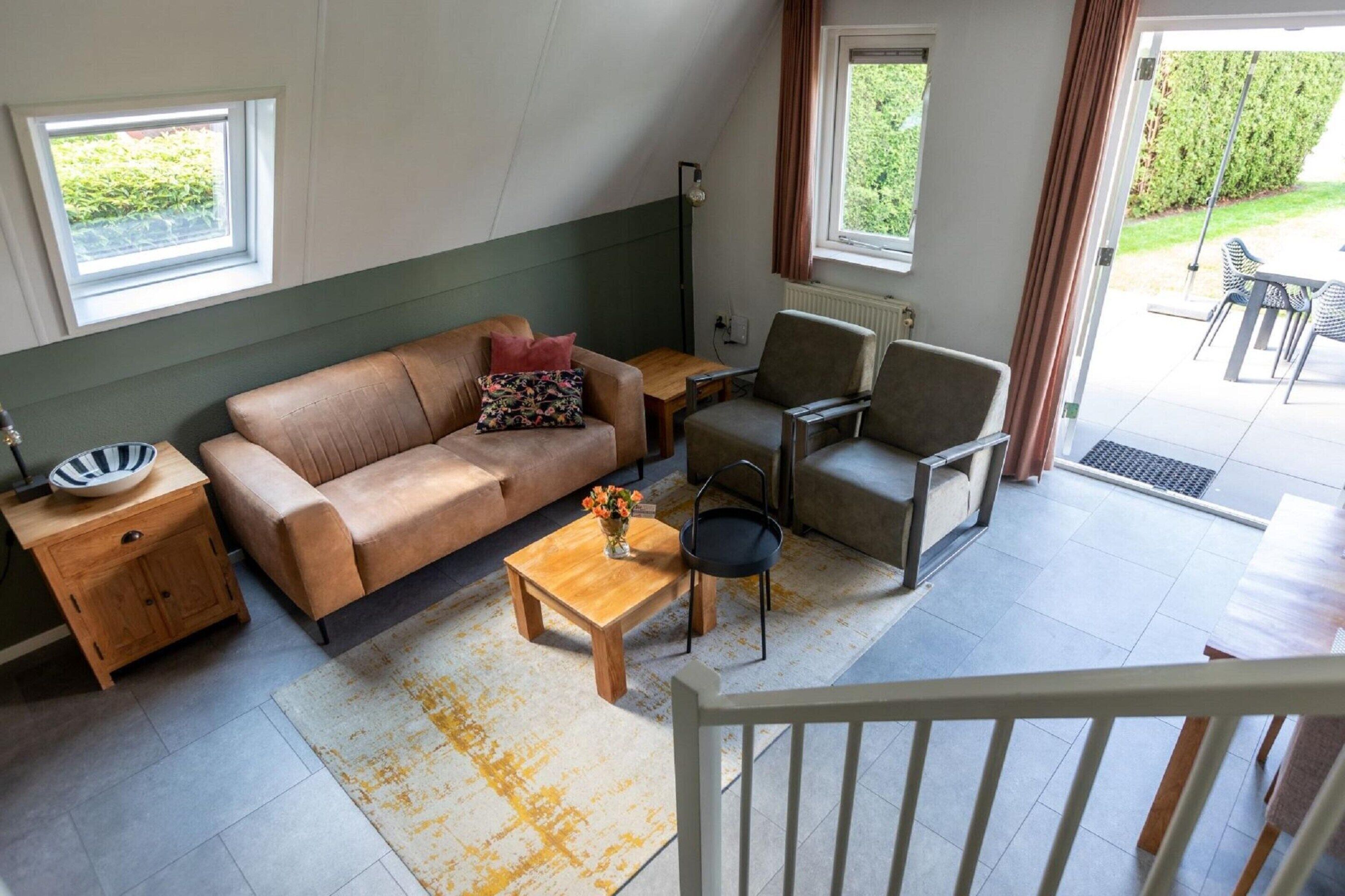 A cozy living room with a sofa, armchair, coffee table, and a small side table.